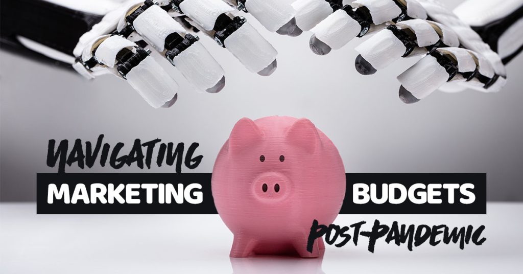 A pink piggy bank on a grey background with robot fingers hovering over the top and the text: Navigating Marketing Budgets Post-Pandemic