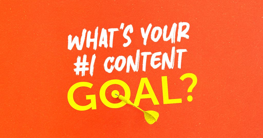 A motivational image with a bright orange background featuring bold, white and yellow text that reads 'What's your #1 content goal?' A yellow dart is positioned, hitting the center of the letter 'O' in the word 'GOAL', symbolizing focus and achievement.